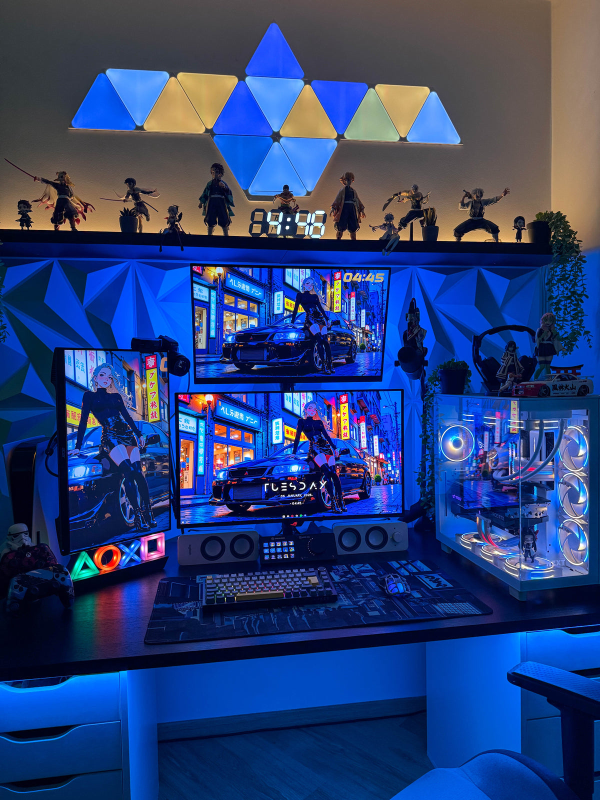 Setups contest winner: triangle light panels, anime figures, three monitors and a white PC with blue-lit fans