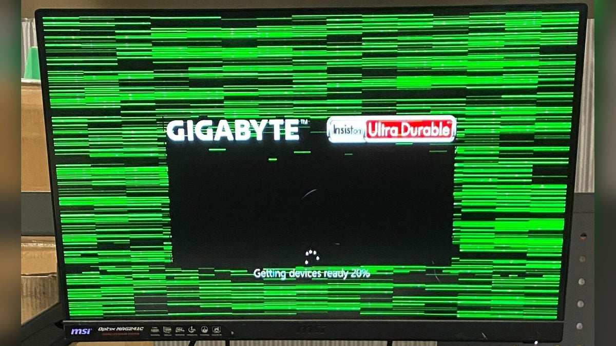 Monitor covered in green horizontal lines and blocks, a typical sign of GPU artifacting
