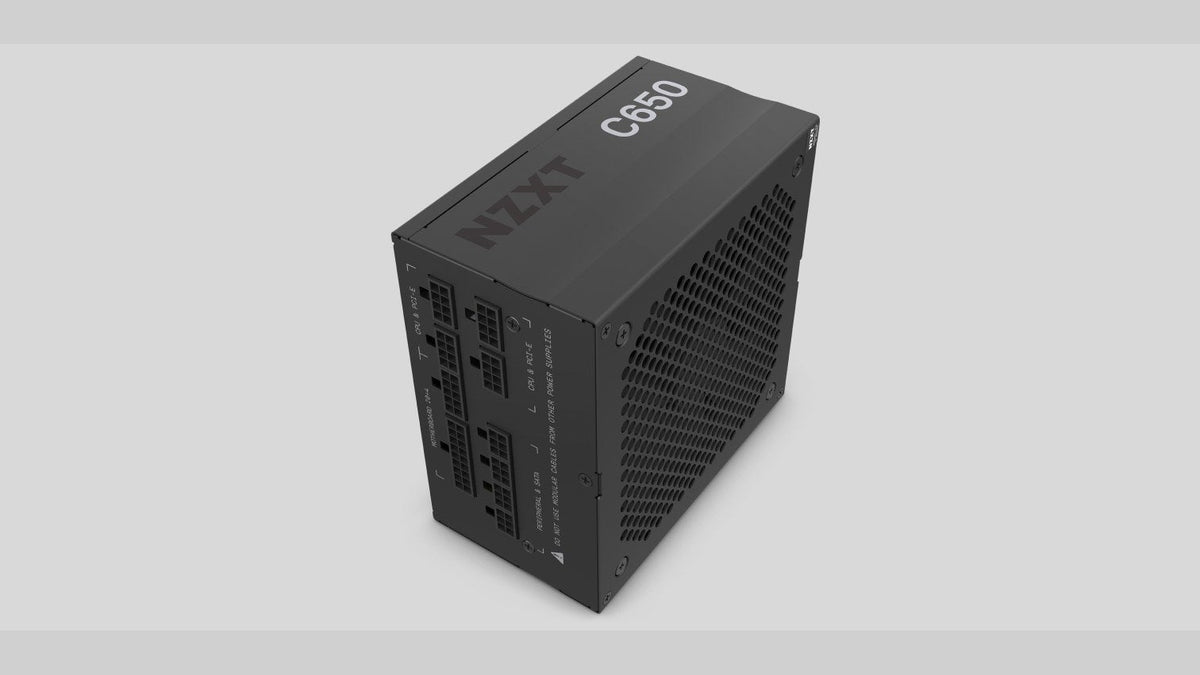 Black NZXT C650 power supply viewed from above, showing its modular cable ports and mesh fan grille
