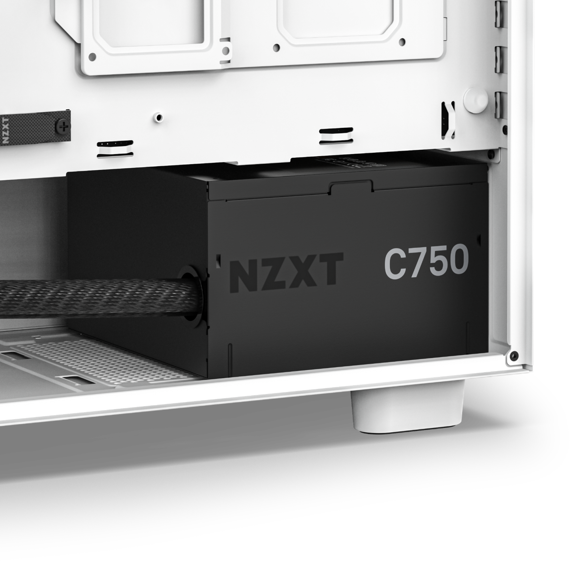 Close-up of the NZXT C750 Bronze (2023) power supply installed in a white PC case, showcasing reliable high-performance power—an essential choice for serious PC gamers.
