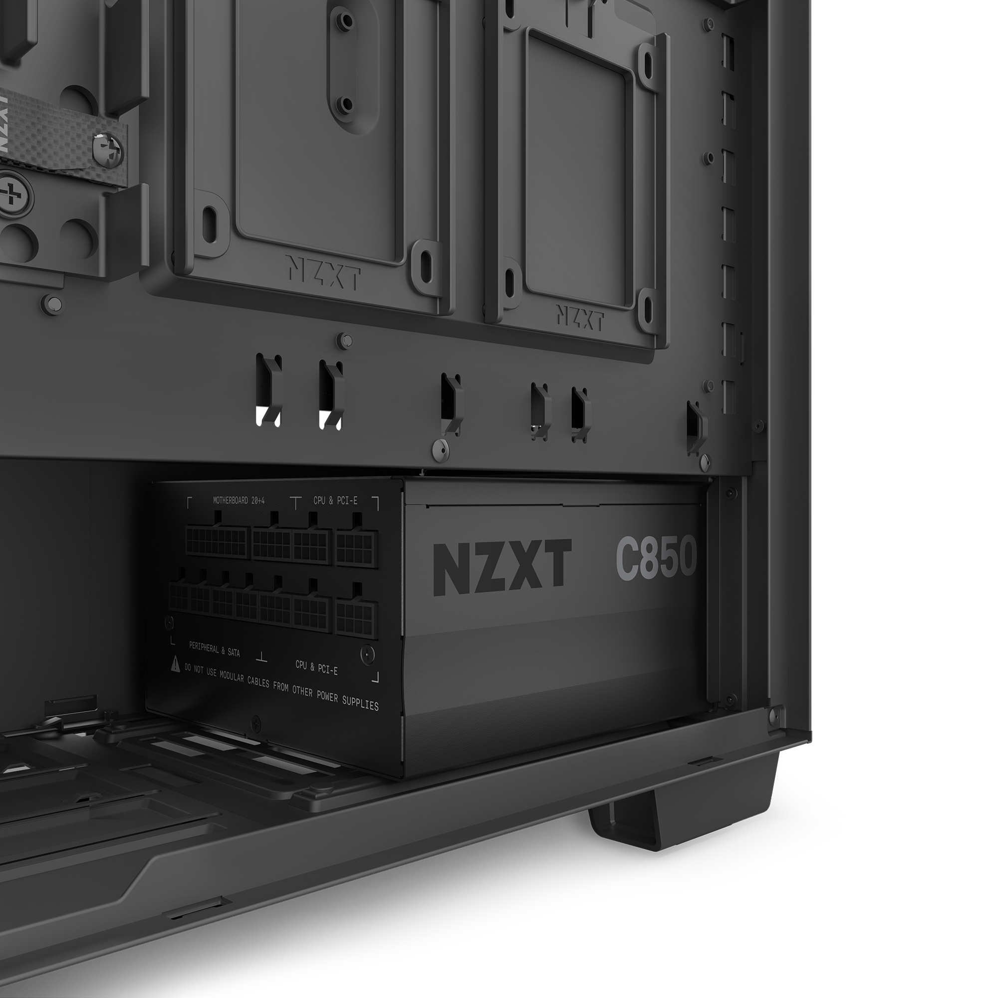 Close-up of the NZXT C850 Gold (2022) modular power supply installed in a computer case, with visible mounting brackets and cable management. The grayscale image highlights its efficient zero RPM fan mode.