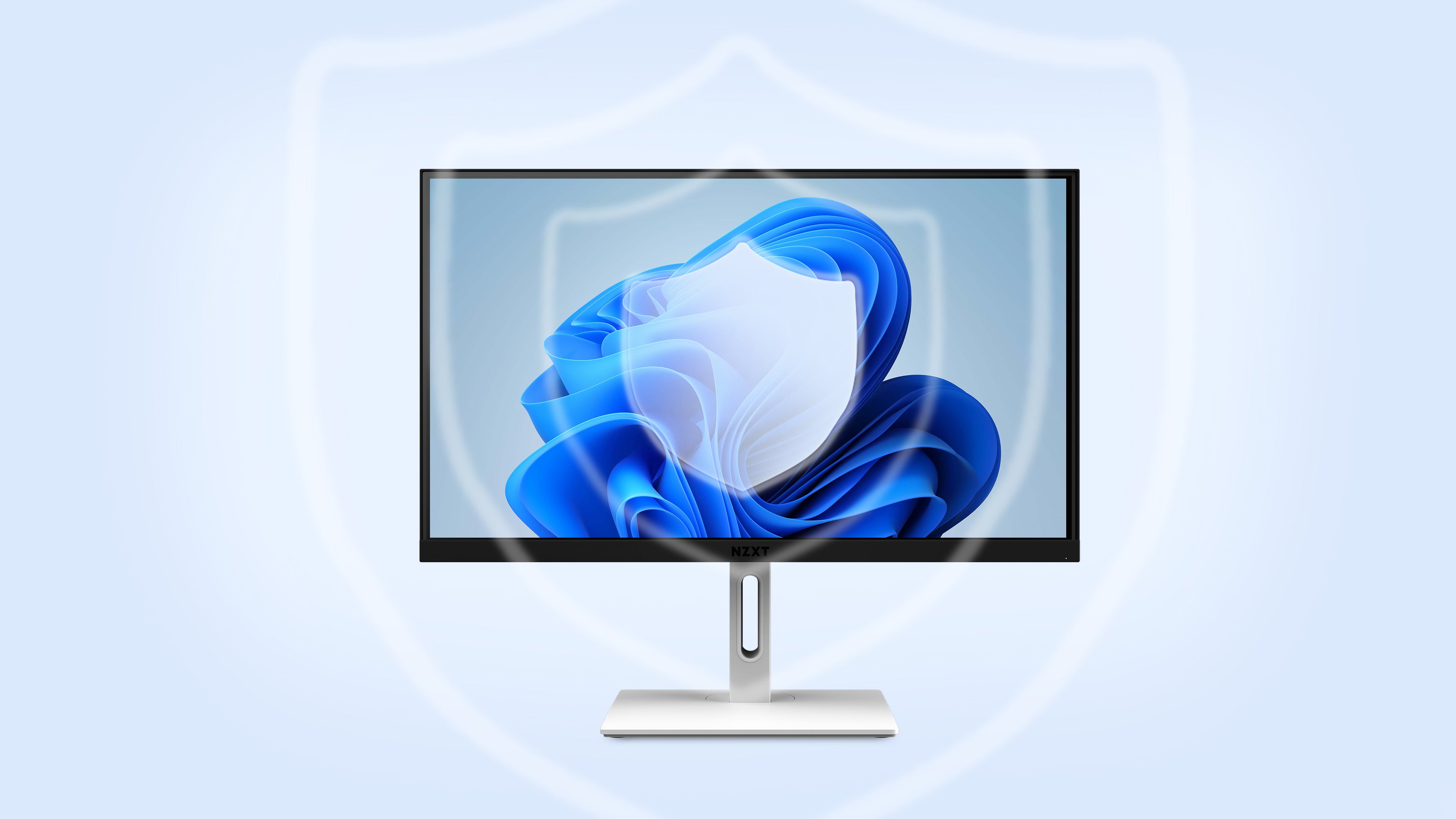 A computer monitor displaying the Windows 11 logo with a large, semi-transparent shield icon in the background, symbolizing digital security or protection.